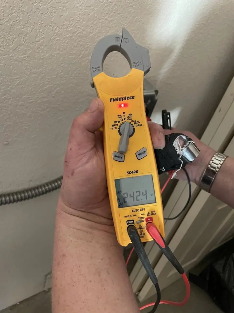 Voltage testing with clamp meter during Ceiling Fan Installation in Harvard